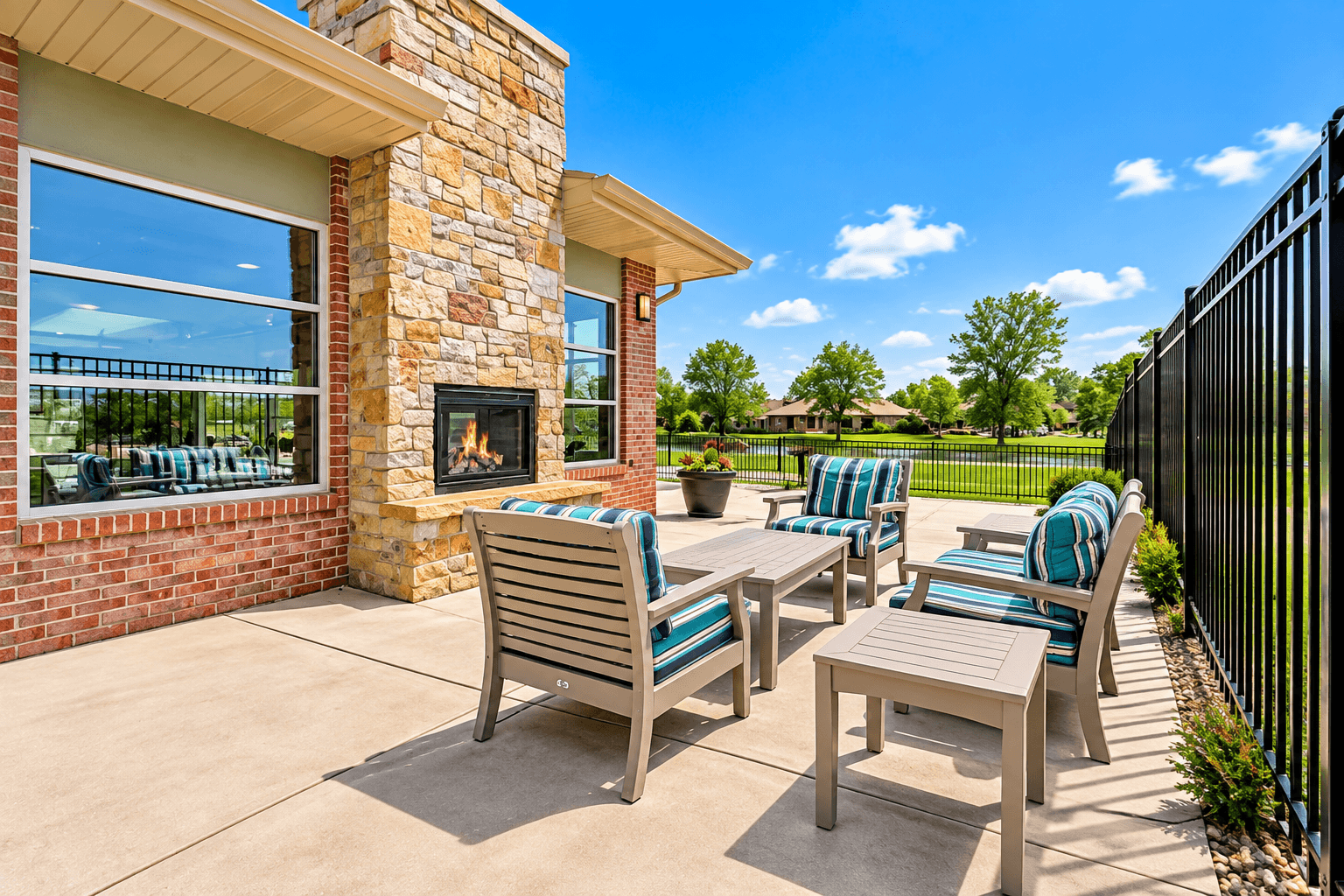 A patio with a fireplace and chairs.